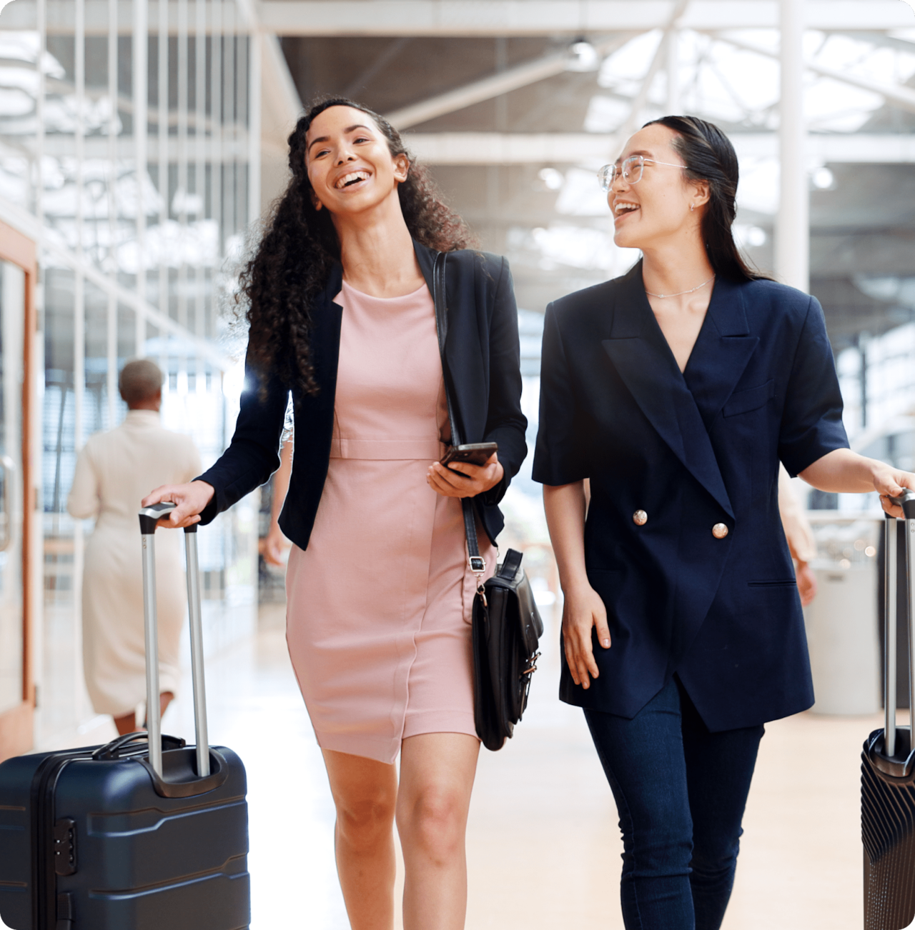 2 professional women walking through an airport terminal